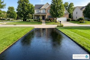 freshly sealed deep-black asphalt driveway
